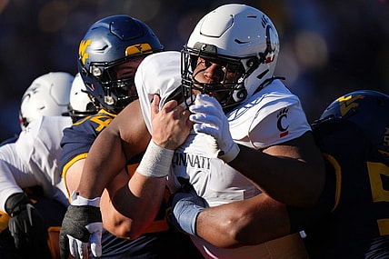 Nov 18, 2023; Morgantown, West Virginia, USA; Cincinnati Bearcats defensive lineman Dontay Corleone (2) is double-teamed on a pass rush against the West Virginia Mountaineers in the first quarter at Milan Puskar Stadium.  Mandatory Credit: Kareem Elgazzar-USA TODAY Sports