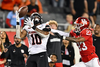 Nov 18, 2023; Houston, Texas, USA; Oklahoma State Cowboys wide receiver Rashod Owens (10) catches a pass during the fourth quarter as Houston Cougars defensive back Isaiah Hamilton (23) defends at TDECU Stadium. Mandatory Credit: Maria Lysaker-USA TODAY Sports