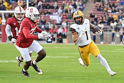 Nov 18, 2023; Stanford, California, USA; California Golden Bears running back Jaydn Ott (1) runs with the football against Stanford Cardinal linebacker David Bailey (23) during the first quarter at Stanford Stadium. Mandatory Credit: Robert Edwards-USA TODAY Sports