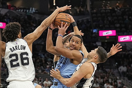 Nov 18, 2023; San Antonio, Texas, USA; Memphis Grizzlies guard Desmond Bane (22) looks to pass the ball while defended by San Antonio Spurs forwards Dom Barlow (26) and Doug McDermott (17) during the second half at Frost Bank Center. Mandatory Credit: Scott Wachter-USA TODAY Sports