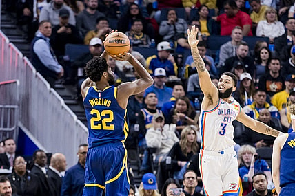 Nov 18, 2023; San Francisco, California, USA; Golden State Warriors forward Andrew Wiggins (22) takes a three-point shot as Oklahoma City Thunder guard Josh Giddey (3) defends during the first half at Chase Center. Mandatory Credit: John Hefti-USA TODAY Sports