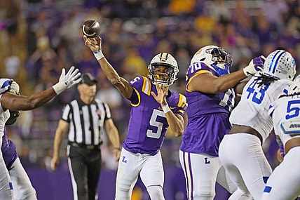 Nov 18, 2023; Baton Rouge, Louisiana, USA; LSU Tigers quarterback Jayden Daniels (5) throws a pass in the third quarter as offensive lineman Miles Frazier (70) blocks Georgia State Panthers linebacker Chris Davis Jr. (43) at Tiger Stadium. Mandatory Credit: Matthew Dobbins-USA TODAY Sports