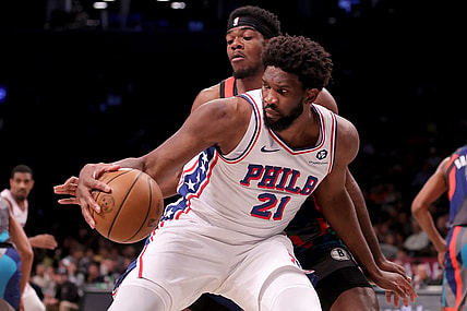 Nov 19, 2023; Brooklyn, New York, USA; Philadelphia 76ers center Joel Embiid (21) controls the ball against Brooklyn Nets center Day'Ron Sharpe (20) during the second quarter at Barclays Center. Mandatory Credit: Brad Penner-USA TODAY Sports