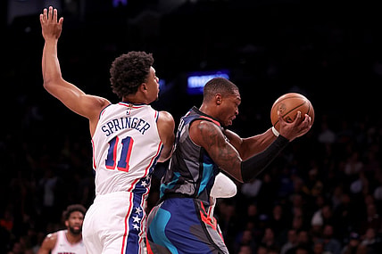 Nov 19, 2023; Brooklyn, New York, USA; Brooklyn Nets guard Lonnie Walker IV (8) grabs a rebound against Philadelphia 76ers guard Jaden Springer (11) during the first quarter at Barclays Center. Mandatory Credit: Brad Penner-USA TODAY Sports