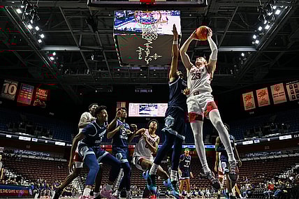 Nov 19, 2023; Uncasville, CT, USA; Washington State Cougars forward Andrej Jakimovski (23) jumps to shoot the ball challenged by Rhode Island Rams guard Zek Montgomery (0) during the second half at Mohegan Sun Arena. Mandatory Credit: Mark Smith-USA TODAY Sports