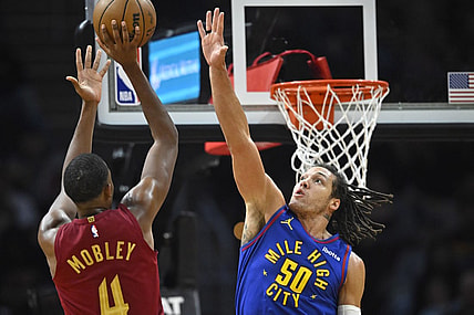 Nov 19, 2023; Cleveland, Ohio, USA; Cleveland Cavaliers forward Evan Mobley (4) shoots beside Denver Nuggets forward Aaron Gordon (50) in the second quarter at Rocket Mortgage FieldHouse. Mandatory Credit: David Richard-USA TODAY Sports