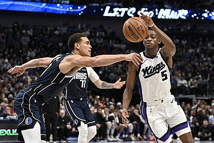 Nov 19, 2023; Dallas, Texas, USA;Dallas Mavericks center Dwight Powell (7) and Sacramento Kings guard De'Aaron Fox (5) battle for control of a loose ball during the second quarter at the American Airlines Center. Mandatory Credit: Jerome Miron-USA TODAY Sports