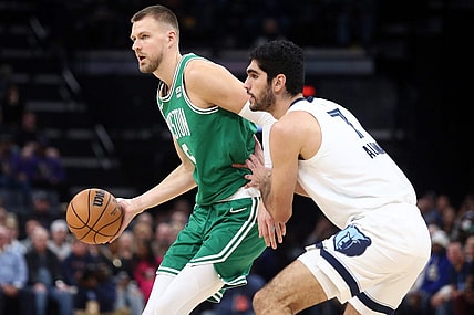 Nov 19, 2023; Memphis, Tennessee, USA; Boston Celtics center Kristaps Porzingis (8) passes as Memphis Grizzlies forward-center Santi Aldama (7) defends during the first half at FedExForum. Mandatory Credit: Petre Thomas-USA TODAY Sports