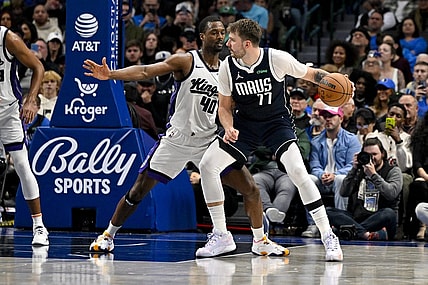 Nov 19, 2023; Dallas, Texas, USA; Dallas Mavericks guard Luka Doncic (77) looks to move the ball past Sacramento Kings forward Harrison Barnes (40) during the second half at the American Airlines Center. Mandatory Credit: Jerome Miron-USA TODAY Sports