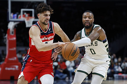 Nov 20, 2023; Washington, District of Columbia, USA; Washington Wizards forward Deni Avdija (8) drives to the basket as Milwaukee Bucks guard Damian Lillard (0) defends in the first quarter at Capital One Arena. Mandatory Credit: Geoff Burke-USA TODAY Sports