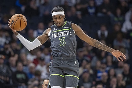 Nov 20, 2023; Minneapolis, Minnesota, USA; Minnesota Timberwolves forward Jaden McDaniels (3) jumps up to save a loose ball against the New York Knicks in the first half at Target Center. Mandatory Credit: Jesse Johnson-USA TODAY Sports