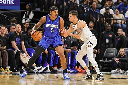 Nov 22, 2023; Orlando, Florida, USA; Denver Nuggets forward Michael Porter Jr. (1) defends Orlando Magic forward Paolo Banchero (5) during the first quarter at Amway Center. Mandatory Credit: Mike Watters-USA TODAY Sports