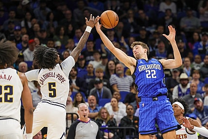 Nov 22, 2023; Orlando, Florida, USA; Orlando Magic forward Franz Wagner (22) and Denver Nuggets guard Kentavious Caldwell-Pope (5) battle for the ball during the second quarter at Amway Center. Mandatory Credit: Mike Watters-USA TODAY Sports