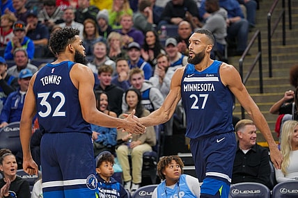 Nov 22, 2023; Minneapolis, Minnesota, USA; Minnesota Timberwolves center Karl-Anthony Towns (32) congratulates center Rudy Gobert (27) against the Philadelphia 76ers in the third quarter at Target Center. Mandatory Credit: Brad Rempel-USA TODAY Sports