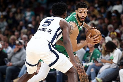 Nov 19, 2023; Memphis, Tennessee, USA; Boston Celtics forward Jayson Tatum (0) handles the ball as Memphis Grizzlies guard Vince Williams Jr. (5) defends during the first half at FedExForum. Mandatory Credit: Petre Thomas-USA TODAY Sports