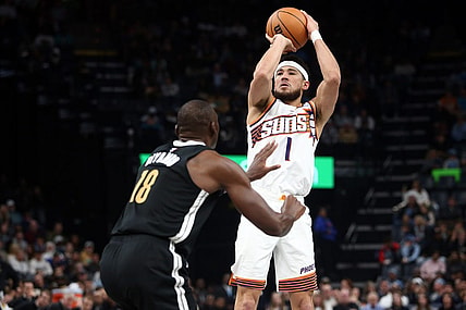 Nov 24, 2023; Memphis, Tennessee, USA; Phoenix Suns guard Devin Booker (1) shoots during the first half against the Memphis Grizzlies at FedExForum. Mandatory Credit: Petre Thomas-USA TODAY Sports