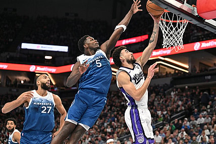 Nov 24, 2023; Minneapolis, Minnesota, USA; Minnesota Timberwolves guard Anthony Edwards (5) blocks the shot of Sacramento Kings guard Chris Duarte (3) as center Rudy Gobert (27) looks on during the first quarter at Target Center. Mandatory Credit: Jeffrey Becker-USA TODAY Sports