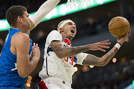 Nov 24, 2023; Milwaukee, Wisconsin, USA;  Washington Wizards forward Kyle Kuzma (33) shoots against Milwaukee Bucks center Brook Lopez (11) during the second quarter at Fiserv Forum. Mandatory Credit: Jeff Hanisch-USA TODAY Sports