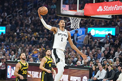 November 24, 2023; San Francisco, California, USA; San Antonio Spurs center Victor Wembanyama (1) dunks the basketball against Golden State Warriors guard Stephen Curry (30) and guard Klay Thompson (11) during the first quarter at Chase Center. Mandatory Credit: Kyle Terada-USA TODAY Sports