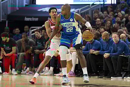 Nov 24, 2023; Milwaukee, Wisconsin, USA;  Milwaukee Bucks forward Khris Middleton (22) dribbles the ball as Washington Wizards guard Jordan Poole (13) defends during the first quarter at Fiserv Forum. Mandatory Credit: Jeff Hanisch-USA TODAY Sports