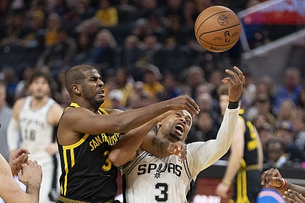 November 24, 2023; San Francisco, California, USA; Golden State Warriors guard Chris Paul (3, left) and San Antonio Spurs forward Keldon Johnson (3, right) fight for the rebound during the first quarter at Chase Center. Mandatory Credit: Kyle Terada-USA TODAY Sports