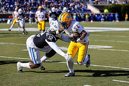 Nov 25, 2023; Durham, North Carolina, USA; Duke Blue Devils linebacker Tre Freeman (12) tacks Pittsburgh Panthers running back C'Bo Flemister (24) during the first half of the game at Wallace Wade Stadium. Mandatory Credit: Jaylynn Nash-USA TODAY Sports