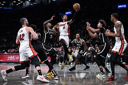 Nov 25, 2023; Brooklyn, New York, USA; Miami Heat guard Josh Richardson (0) drives to the basket against Brooklyn Nets forward Dorian Finney-Smith (28) and  guard Lonnie Walker IV (8) and forward Cameron Johnson (2) during the second quarter at Barclays Center. Mandatory Credit: John Jones-USA TODAY Sports