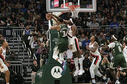 Nov 26, 2023; Milwaukee, Wisconsin, USA;  Portland Trail Blazers forward Jerami Grant (9) defends Milwaukee Bucks forward Giannis Antetokounmpo (34) during the fourth quarter at Fiserv Forum. Mandatory Credit: Jeff Hanisch-USA TODAY Sports