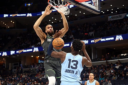 Nov 24, 2023; Memphis, Tennessee, USA; Minnesota Timberwolves center Rudy Gobert (27) dunks over Memphis Grizzlies forward-center Jaren Jackson Jr. (13) during the first half at FedExForum. Mandatory Credit: Petre Thomas-USA TODAY Sports