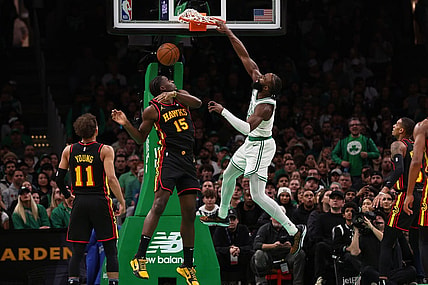 Nov 26, 2023; Boston, Massachusetts, USA; Boston Celtics guard Jaylen Brown (7) dunks over Atlanta Hawks center Clint Capela (15) during the second quarter at TD Garden. Mandatory Credit: Winslow Townson-USA TODAY Sports
