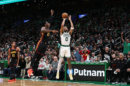 Nov 26, 2023; Boston, Massachusetts, USA; Boston Celtics forward Jayson Tatum (0) shoots against Atlanta Hawks forward Onyeka Okongwu (17) during the second half at TD Garden. Mandatory Credit: Winslow Townson-USA TODAY Sports