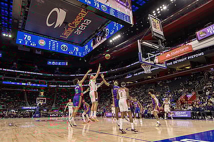 Nov 27, 2023; Detroit, Michigan, USA; Washington Wizards forward Corey Kispert (24) shoots the ball between Detroit Pistons guard Cade Cunningham (2) and guard Killian Hayes (7) during the second half at Little Caesars Arena. Mandatory Credit: David Reginek-USA TODAY Sports