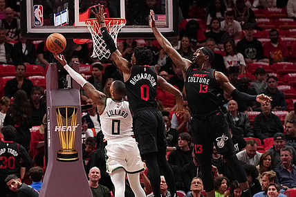 Nov 28, 2023; Miami, Florida, USA; Milwaukee Bucks guard Damian Lillard (0) puts up a shot against Miami Heat guard Josh Richardson (0) during the first half at Kaseya Center. Mandatory Credit: Jasen Vinlove-USA TODAY Sports