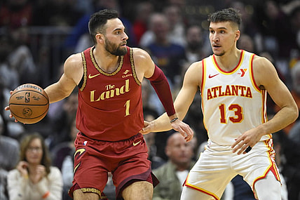 Nov 28, 2023; Cleveland, Ohio, USA; Atlanta Hawks guard Bogdan Bogdanovic (13) defends Cleveland Cavaliers guard Max Strus (1) in the second quarter at Rocket Mortgage FieldHouse. Mandatory Credit: David Richard-USA TODAY Sports