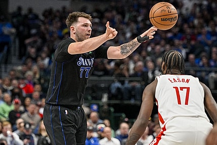 Nov 28, 2023; Dallas, Texas, USA; Dallas Mavericks guard Luka Doncic (77) passes the ball over Houston Rockets forward Tari Eason (17) during the second quarter at the American Airlines Center. Mandatory Credit: Jerome Miron-USA TODAY Sports