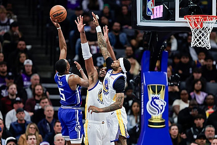 Nov 28, 2023; Sacramento, California, USA; Sacramento Kings guard De'Aaron Fox (5) shoots over Golden State Warriors guard Gary Payton II (0) during the third  quarter at Golden 1 Center. Mandatory Credit: Sergio Estrada-USA TODAY Sports