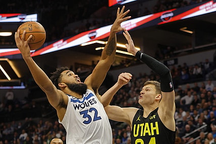 Nov 30, 2023; Minneapolis, Minnesota, USA; Minnesota Timberwolves forward Karl-Anthony Towns (32) shoots against Utah Jazz center Walker Kessler (24) in the first quarter at Target Center. Mandatory Credit: Bruce Kluckhohn-USA TODAY Sports