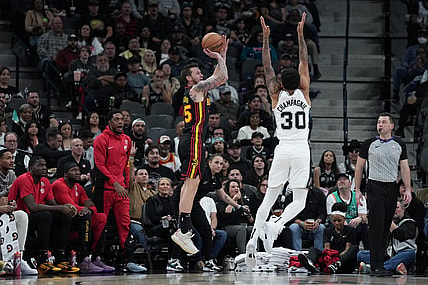 Nov 30, 2023; San Antonio, Texas, USA;  Atlanta Hawks guard Garrison Mathews (25) shoots over San Antonio Spurs forward Julian Champagnie (30) in the first half at the Frost Bank Center. Mandatory Credit: Daniel Dunn-USA TODAY Sports
