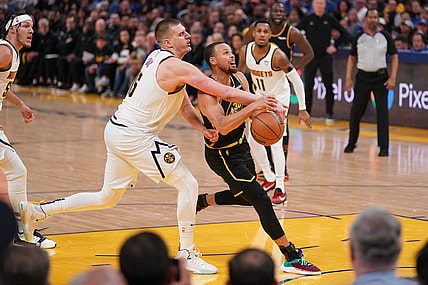 Apr 27, 2022; San Francisco, California, USA; Golden State Warriors guard Stephen Curry (30) has the ball knocked out of his hands by Denver Nuggets center Nikola Jokic (15) in the third quarter during game five of the first round for the 2022 NBA playoffs at Chase Center. Mandatory Credit: Cary Edmondson-USA TODAY Sports