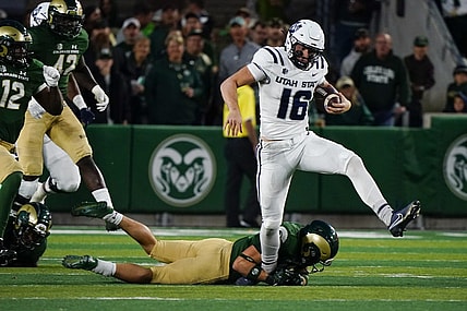 Oct 15, 2022; Fort Collins, Colorado, USA; Utah State Aggies quarterback Levi Williams (16) can't escape the grasp of a Colorado State Rams defender at Sonny Lubick Field at Canvas Stadium. Mandatory Credit: Michael Madrid-USA TODAY Sports