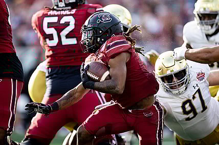Dec 30, 2022; Jacksonville, FL, USA; South Carolina Gamecocks wide receiver Antwane Wells Jr. (3) runs with the ball away from Notre Dame Fighting Irish defensive lineman Gabriel Rubio (97) during the first half in the 2022 Gator Bowl at TIAA Bank Field. Mandatory Credit: Matt Pendleton-USA TODAY Sports