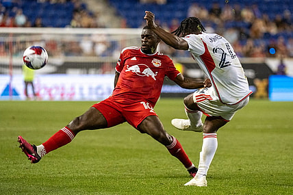 Jul 22, 2023; Harrison, NJ, USA; New York Red Bulls midfielder Dru Yearwood (16) blocks a pass by New England Revolution forward DeJuan Jones (24) during the second half at Red Bull Arena. Mandatory Credit: Mark Smith-USA TODAY Sports