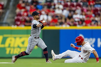 Aug 15, 2023; Cincinnati, Ohio, USA; Cleveland Guardians second baseman Andres Gimenez (0) forces out Cincinnati Reds centerfielder TJ Hopkins at second and throws to first to get Kevin Newman (not pictured) out to complete the double play in the fifth inning at Great American Ball Park. Mandatory Credit: Katie Stratman-USA TODAY Sports