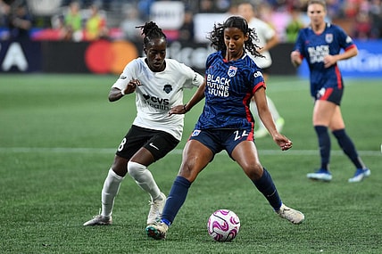 Oct 6, 2023; Seattle, Washington, USA; Washington Spirit forward Ouleymata Sarr (8) and OL Reign defender Ryanne Brown (22) battle for the ball during the second half at Lumen Field. Mandatory Credit: Steven Bisig-USA TODAY Sports