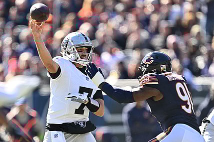 Oct 22, 2023; Chicago, Illinois, USA;  Las Vegas Raiders quarterback Brian Hoyer (7) gets off a pass while being pressured by Chicago Bears defensive lineman Yannick Ngakoue (91) in the second quarter at Soldier Field. Mandatory Credit: Jamie Sabau-USA TODAY Sports
