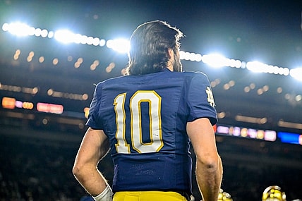 Nov 18, 2023; South Bend, Indiana, USA; Notre Dame Fighting Irish quarterback Sam Hartman (10) watches from the bench in the fourth quarter against the Wake Forest Demon Deacons at Notre Dame Stadium. Mandatory Credit: Matt Cashore-USA TODAY Sports
