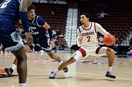 Nov 19, 2023; Uncasville, CT, USA; Washington State Cougars guard Myles Rice (2) dribbles the ball defended by Rhode Island Rams guard Luis Kortright (1) during the second half at Mohegan Sun Arena. Mandatory Credit: Mark Smith-USA TODAY Sports