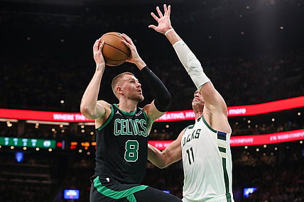 Nov 22, 2023; Boston, Massachusetts, USA; Boston Celtics center Kristaps Porzingis (8) drives to the basket defended by Milwaukee Bucks center Brook Lopez (11) during the first half at TD Garden. Mandatory Credit: Paul Rutherford-USA TODAY Sports