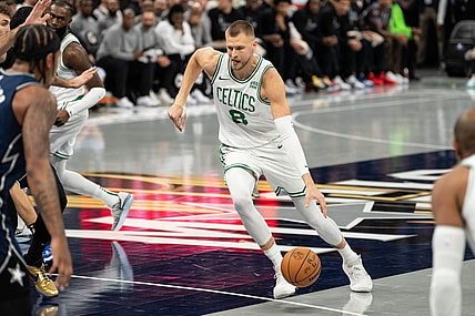 Nov 24, 2023; Orlando, Florida, USA; Boston Celtics forward Kristaps Porzingis (8) dribbles the ball against the Orlando Magic in the first quarter at Amway Center. Mandatory Credit: Jeremy Reper-USA TODAY Sports