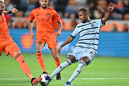 Nov 26, 2023; Houston, Texas, USA; Sporting Kansas City midfielder Gadi Kinda (10) shoots the ball against Houston Dynamo midfielder Hector Herrera (16) during the first half for the MLS Cup Western Conference Semifinal match at Shell Energy Stadium. Mandatory Credit: Maria Lysaker-USA TODAY Sports